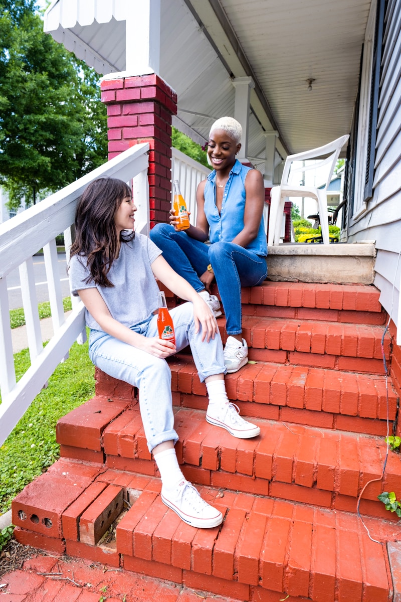 landlord and tenant with renters insurance sitting on red concrete stairs